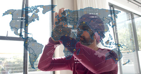 Raising Indian man with turban, glasses manipulating AR world map in bright office, maroon top. Holographic, augmented, interaction, overlay, visualization, grid, nodesの写真素材