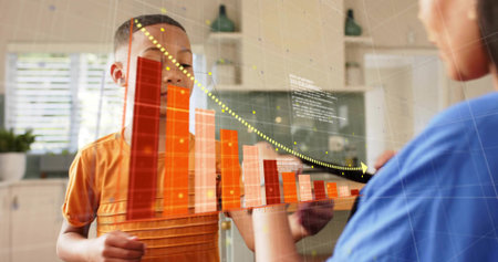 Standing boy in orange shirt viewing AR bar chart in home-kitchen, woman in blue-top touching....