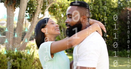 Embracing couple in sunlit backyard, woman wearing mint top, man wearing white tee, binary overlay....