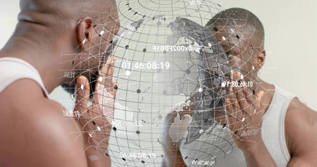 Inspecting man wearing white tank top touching face at wall mirror, with AR globe overlay....