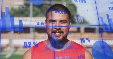 Standing man wearing red sleeveless jersey on grassy field with bleachers, blue data overlays....