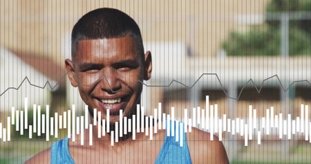 Standing man smiling, wearing blue tank in sunny residential area with white equalizer bars....