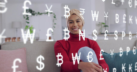 Smiling woman in beige turban and red turtleneck holding knees on sofa, with icons overlay....