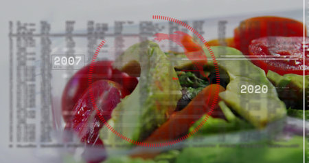 Displaying salad with avocado slices, cherry tomatoes in clear plate on table. Greens, vibrant,...