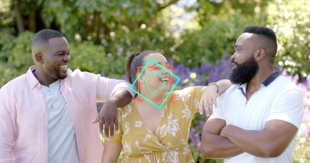 Laughing woman wearing yellow floral dress leaning in garden with light pink shirt, white polo near....