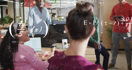 Sitting woman wearing maroon top collaborating at wooden table in office, with laptops and formulas....