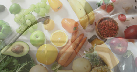 Rinsing mid-adult woman wearing light top handling assorted produce at kitchen counter, with faucet....