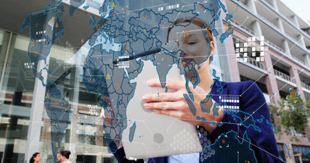 Holding tablet woman at office plaza glass buildings wearing navy blazer showing holographic map....