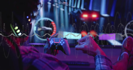 Playing man in plaid shirt holding wireless gamepad at desk with RGB screens, waveform, copy space....