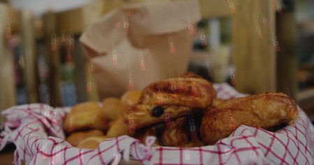 Displaying woven basket holding golden pastries on bakery counter with checked towel and paper bag....