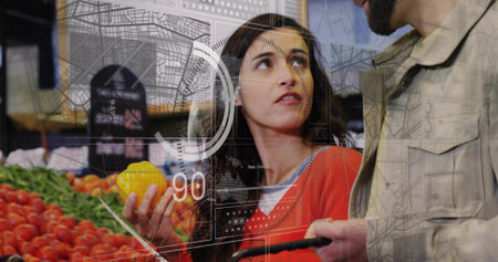 Holding yellow pepper, woman in red sweater talking to man holding cart handle in supermarket, HUD....