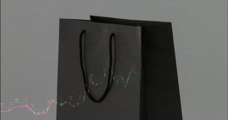 Showing matte black paper bags with U rope handles on textured gray backdrop, candlestick overlay....