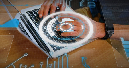 Typing adult hands using silver laptop on wooden desk, wearing smartwatch, showing HUD overlays....