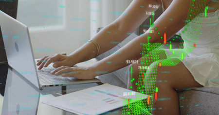 Typing Chinese woman white-sleeveless-dress at home with silver laptop, charts and digital overlays....