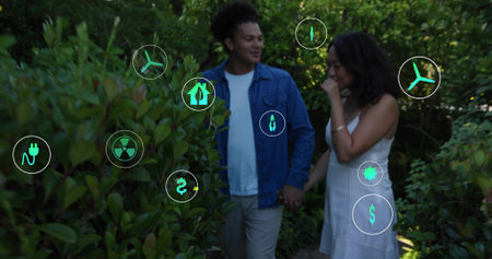 Walking couple wearing blue jacket, white dress holding hands on shrub-lined garden path, HUD icons....