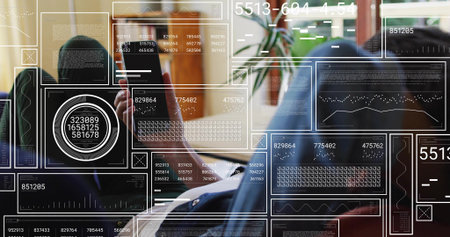 Using phone, mature woman wearing blazer seated at home-office viewing HUD with plant, shelf, glare....