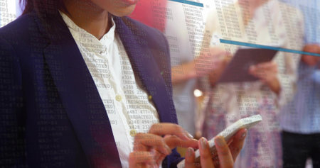 Typing adult woman in dark navy blazer tapping white phone at conference, tablet and code overlay....