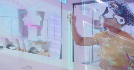 Reaching man wearing yellow tee white VR headset interacting with HUD at office, copy space....