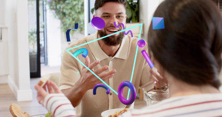 Talking bearded man in beige polo gesturing at dining table with noodle bowl, pitcher, AR graphics....