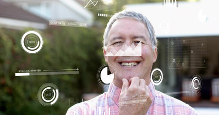 Smiling senior man wearing pink checkered shirt facing lens in backyard, showing AR dials, charts....