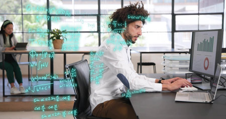 Typing male analyst in white shirt, brown pants at desk, viewing monitor charts and glass formulas....