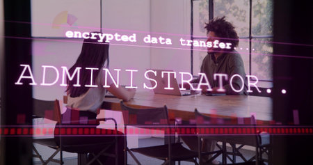 Reviewing colleagues in business-casual viewing encrypted overlay on laptop at office meeting table....