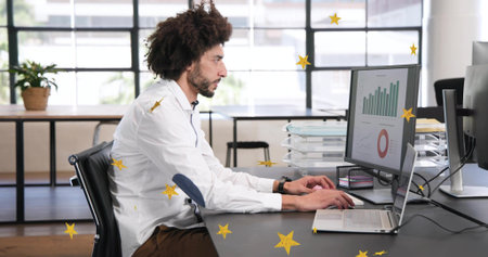 Typing Middle-Eastern man in white-shirt at office desk, viewing bar, pie charts with yellow stars....