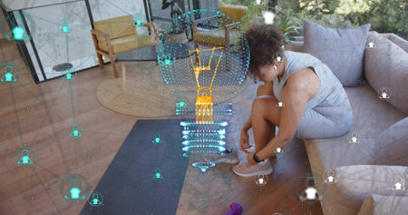 Tying shoe, woman in grey workout-set sitting on couch in livingroom with mat, hologram, copy space....