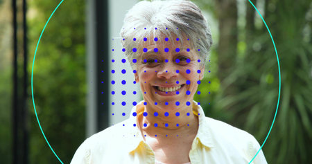 Smiling senior woman standing at doorframe in pale-yellow-shirt, showing teal overlay and blue grid....