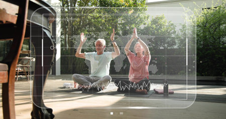 Practicing seniors raising arms on yoga mats on deck, in exercise clothes with water bottle....
