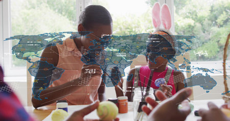Painting woman in peach top guiding child in pink with bunny-ears at home, table, digital overlay....