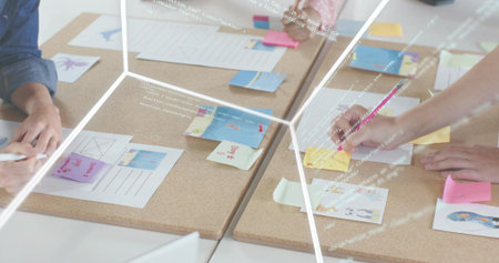 Writing hands sorting sticky notes, layouts on cork boards at office using pink pencil denim sleeve....