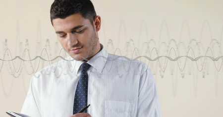 Writing man wearing navy polka-dot tie and light shirt at beige backdrop with pen notebook waveform....