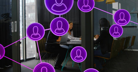 Discussing three staff in glass conference room wearing formal wear, laptop, papers, purple overlay....