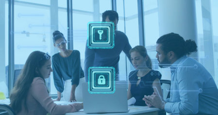 Discussing five team members in business casual leaning over laptop in office, with security icons....