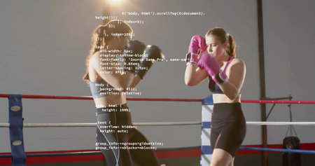 Sparring female boxers trading punches and guarding in gym ring, gloves, sports bras, code overlay....