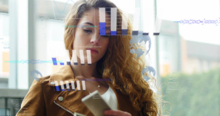 Holding smartphone, woman viewing data overlays on glass window at lobby, in brown jacket. Augmented, digital, phone, professional, interface, interior, modernの写真素材