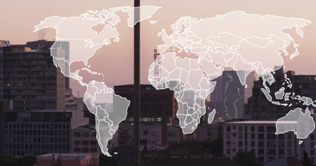 Displaying translucent world map overlay spanning urban skyline at dusk, showing crane and antennas....