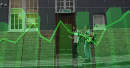 Walking two men checking phone on sidewalk by brick ENTRANCE sign, backpacks, green financial chart. Urban, street, friends, smartphone, headphones, backpack, casualwearの写真素材