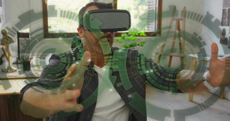 Reaching man wearing checkered shirt and VR headset, using translucent green HUD in home office....