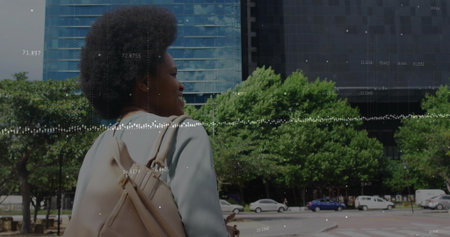 Walking woman wearing light blazer carrying tan backpack along city sidewalk, data overlay. Urban,...