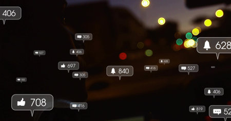 Glancing driver silhouette wearing hoodie checking social alerts inside car at night, copy space....