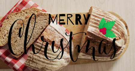 Displaying two artisan loaves being sliced on wooden board with cloth, MERRY Christmas overlay....