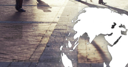Walking legs wearing coats crossing tiled plaza casting long shadows, with world map, copy space....