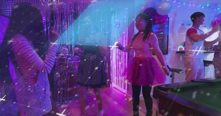 Dancing woman in pink top and fuchsia tutu moving at party room, with pool table. Celebration,...