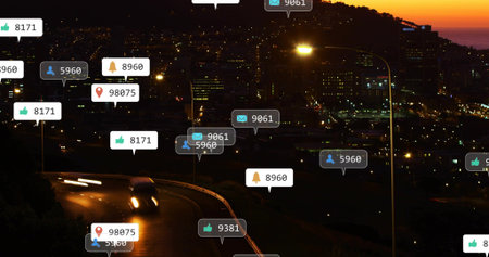 Displaying notification callouts hovering over winding hill road at dusk with vehicle headlights....