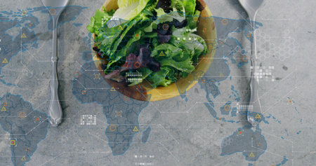 Showing bowl with green purple leaves on concrete table with world map overlays and two spoons....