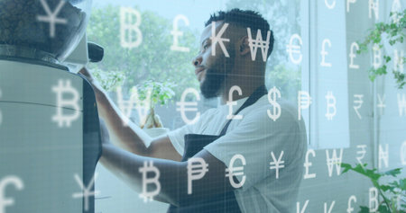 Operating espresso maker, man at cafe wearing white T, dark apron making espresso, currency overlay. Barista, coffee, brew, portafilter, window, daylight, plantsの写真素材