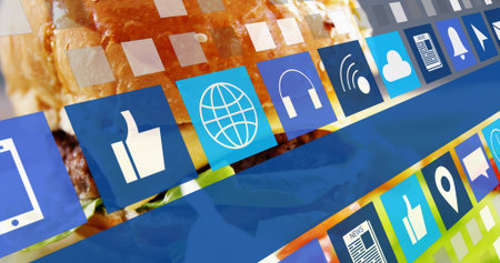 Displaying hamburger with melted cheese and lettuce under floating app icon tiles in studio. Burger,...