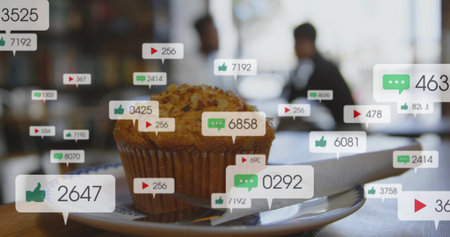 Displaying golden muffin sitting on plate at cafe table, napkin, social-icons, dark-jacket-patrons....